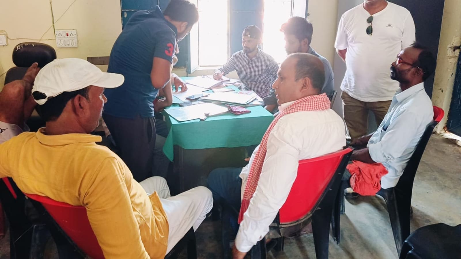 Electoral roll and scheme records being checked at a block office