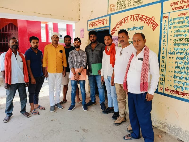 Field staff and local representatives outside a gram panchayat office