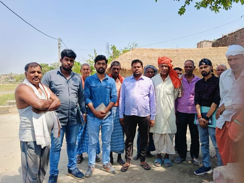 Field staff with residents of an outlying hamlet